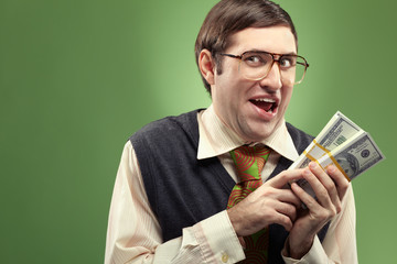 Portrait of a happy nerd counting his money - obrazy, fototapety, plakaty