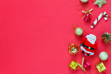 Top view Christmas decoration and Santa Claus doll on red .