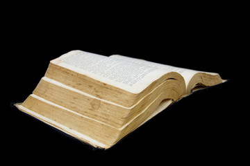Big open book isolated on a black background