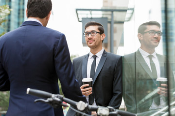 Two businessmen talking outdoors