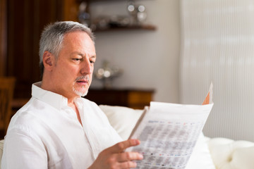 Fototapeta na wymiar Mature man reading a newspaper