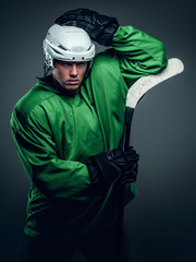 Naklejka premium Hockey player holds gaming stick.