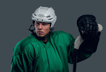 Hockey player holds gaming stick.
