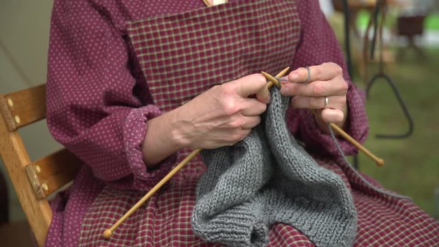 Woman knitting in a civil war camp