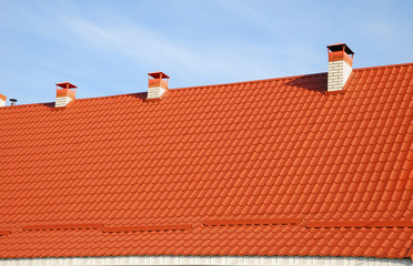 Roofing construction. Close up on metal roofing with roof protection from snow board, snow guard on...