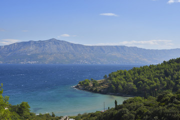 Fototapeta na wymiar Nice beach with blue water and a blue sky, picture from Island Brac in Croatia.