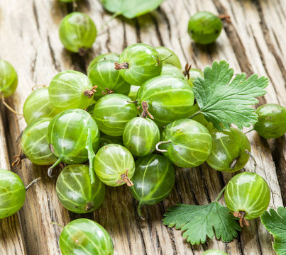 Gooseberries on the wooden table.