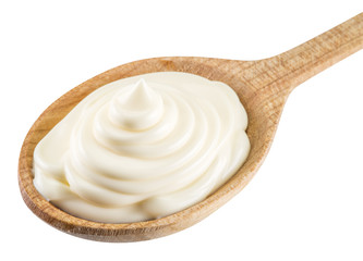 Mayonnaise swirl in the wooden spoon. File contains clipping pat