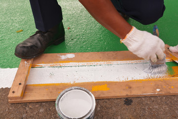 Road painter man worker marking street lines zebra crossing traffic sign using paint brushes