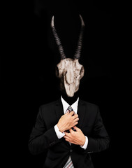 Businessman in suit with skull and horns head