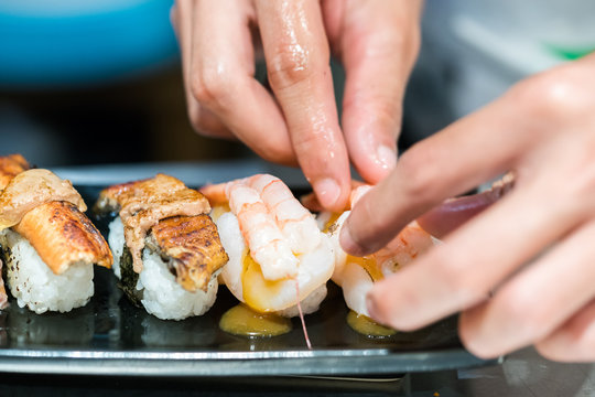 Close up hand of Japanese chef making sushi

