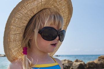 Toddler girl looks in Audrey Hepburn - style glasses