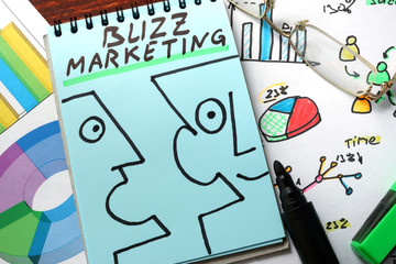 Buzz marketing written on a blue paper.
