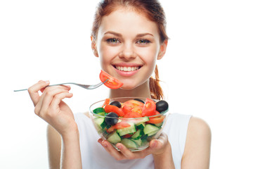 Beautiful woman eating a salad
