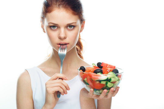Beautiful woman eating a salad
