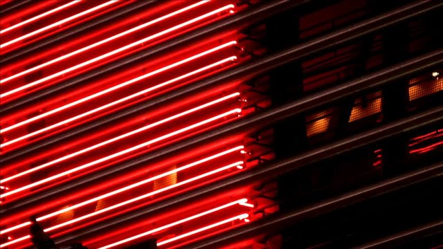 Red neon tubes illuminating on and off on a marquee. HD 1080i.