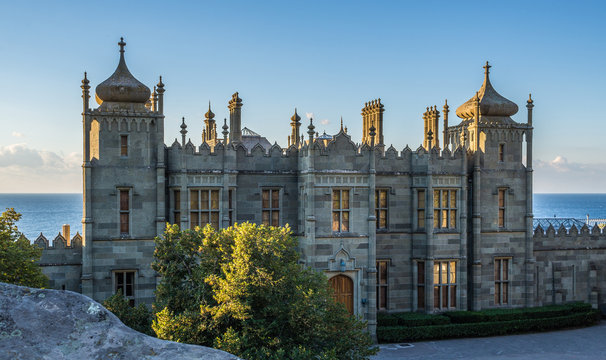 Nothern facade of Vorontsov palace, Alupka, Crimea. The foot of the Crimean Mountains. Blue sky with clouds, marine landscape. 
