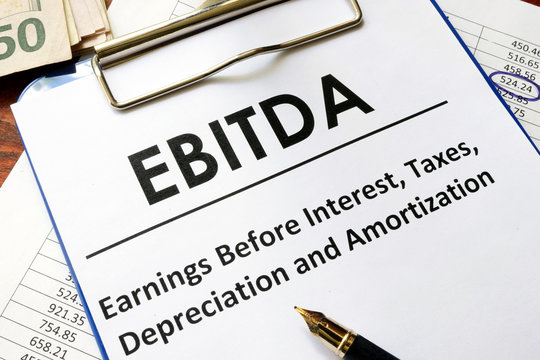 Paper with word ebitda  on a wooden surface.