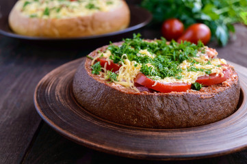 Original appetizer - stuffed rye and wheat bread, baked. Dish in rustic style. Close up