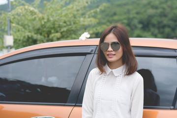 Beautiful young woman portrait wit  autumn trip with orange car.