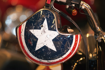 Helmet with the lone star hanging from the handlebar from a motorbike