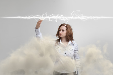 Woman making magic effect - flash lightning. The concept of electricity, high energy.