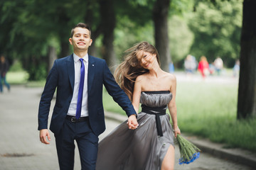 Handsome young couple posing outdoors after ceremony