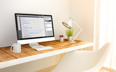 minimalist workplace with coding software computer
