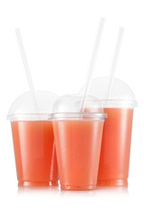 Grapefruit juice in three size of cups - obrazy, fototapety, plakaty