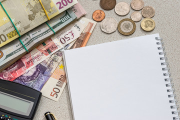 different money with sheet and calculator on desk