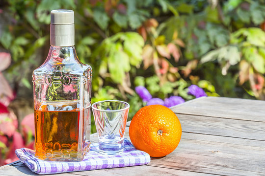 Bottle Tequila With Shot And Orange On Tabel In Garden