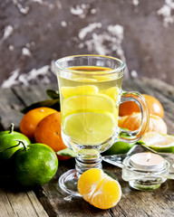 Close up Citrus hot tea.Whole orange and green tangerine.