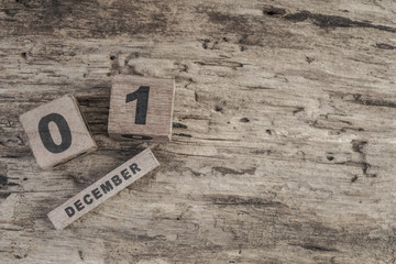cube calendar for december on wooden background with copy space