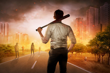 The brave man with baseball bat in his shoulder face several zombie