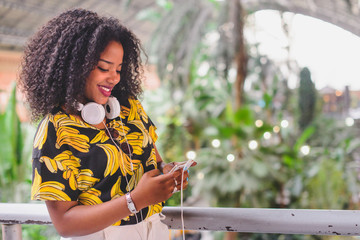 Happy afro-american woman using mobile 