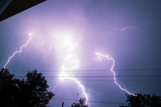 Thunderbolt Over The House And Dark Stormy Sky On The Background