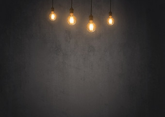 tungsten light bulb on empty blackboard with copy space for inspiration or idea under light bulb