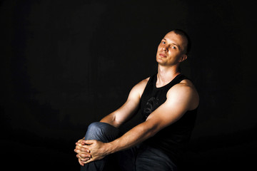 Portrait of young man with strong muscular arms