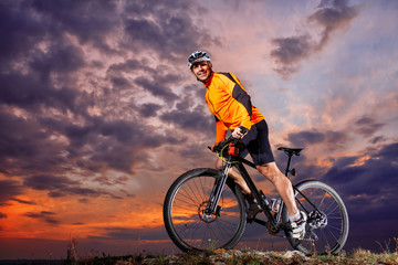 Fototapeta na wymiar Man in helmet and glasses stay on the bicycle