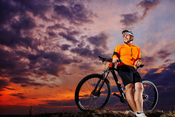 Fototapeta na wymiar Man in helmet and glasses stay on the bicycle