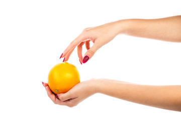 Girl with perfect manicure holding orange in hand