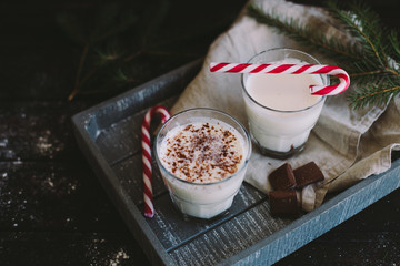 Cocoa with chocolate cups on a dark background (top view)