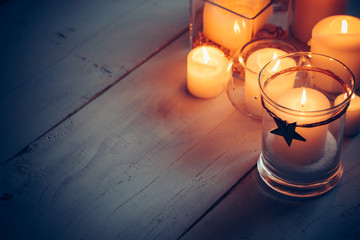Christmas candles on a white wooden background