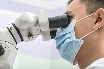 Dentist using a dental microscope