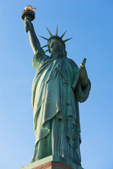 Fototapeta premium Statue of Liberty against blue sky in New York City, United States of America