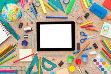 Set of school supplies and tablet screen.