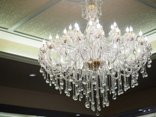 big crystal chandelier and white lighting on the wall