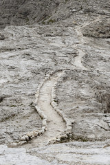 Stone background. Antique  picturesque road in the Dolomites mountains
