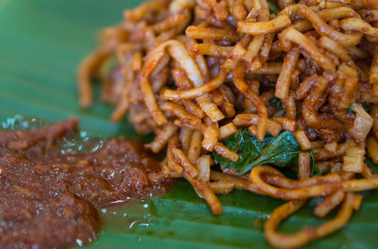 Malaysia food, Fried yellow noodle with chilli paste on green banana leaf