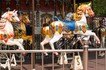 cute Public horse carousel ride at amusement park